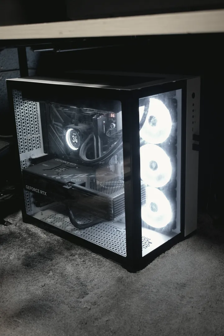 The studio workstation under the desk, cooling fans lit behind a glass panel.